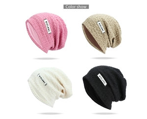 Detailed view of knitted hats in four colors with wave texture and woven brand label