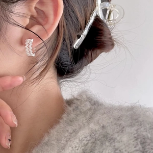 925 Sterling silver wavy stud earrings with sparkling stones shown on model