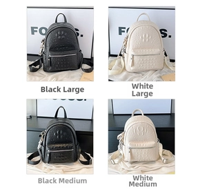 Detail showing black and white crocodile pattern leather backpacks in two sizes with charms