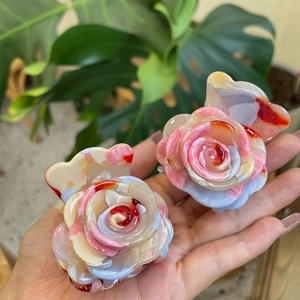 Detailed macro view of acetate floral rose hair claw clips with marble texture
