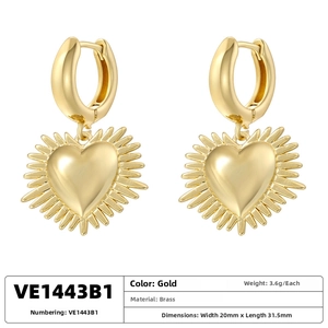 Detailed view of gold-plated brass heart-shaped earrings with radial sunburst patterns