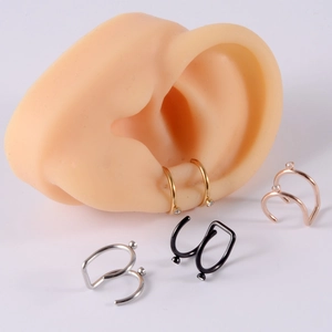 Detailed macro view of U-shaped stainless steel ear cuffs with zircon stones and ball tips