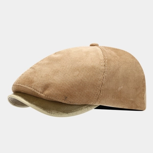 Detailed view of a retro khaki corduroy newsboy cap with a stylish metallic gold brim