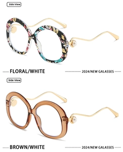 Detail of round floral sunglasses and amber frames with golden wavy pearl temples