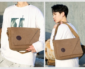 Brown canvas messenger bag detail showing flap cover and adjustable shoulder strap for men