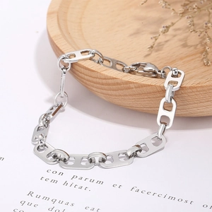 Macro detail of silver stainless steel pig nose chain bracelet with lobster clasp closure