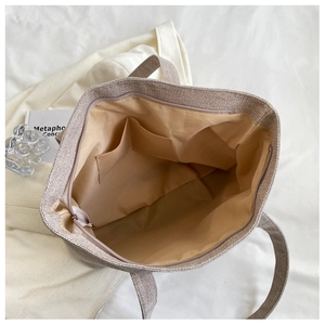 Top view of spacious interior with pockets of this beige linen texture tote bag
