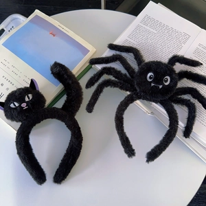 Detail view of plush black cat and spider headbands for Halloween party costumes
