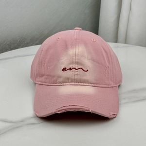 Pink distressed baseball cap with em embroidery and vintage washed cotton finish