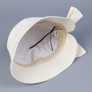 Elegant white summer bucket hat with breathable lining and bow detail for sun protection