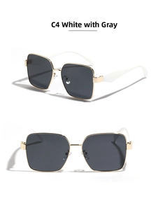 Detail of square gold metal sunglasses with white temples and dark grey lenses