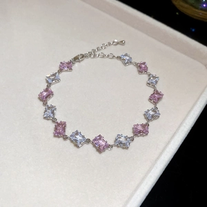 Detail view of silver bracelet with alternating pink and clear baguette-cut zircon stones