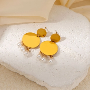 Detailed close-up of gold double-layered round metal plate earrings with pearl drops