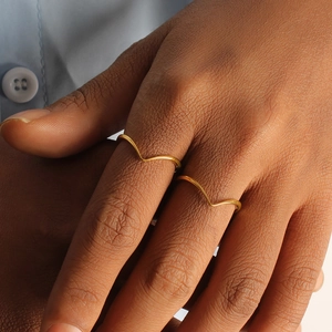 Minimalist gold V-shaped titanium rings for women worn as stacked set on finger