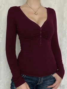 Detailed close-up of deep burgundy Y2K long sleeve top featuring V-neck and button placket