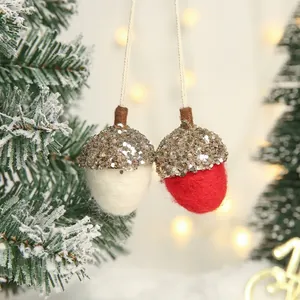 Red and white felt acorn Christmas ornaments with gold glitter on a festive tree
