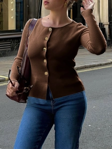 Close-up of brown slim fit knit cardigan with decorative gold buttons on a female model