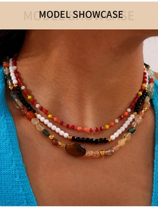 Close-up of bohemian layered beaded necklace with agate stones on a model