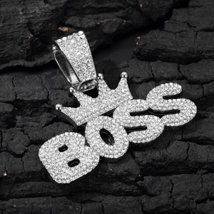 Macro shot of silver BOSS crown pendant with sparkling crystals on Cuban link chain