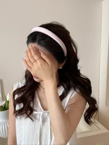 Detail of Korean style pink and white gingham padded headband with soft satin texture