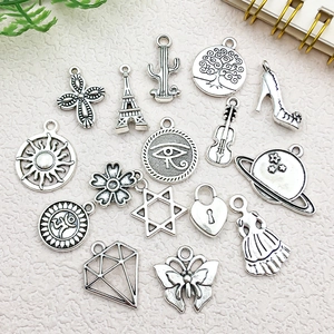 Flat lay of antique silver alloy charms including Eiffel Tower and heart for DIY jewelry
