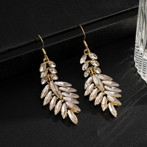 Detail of elegant gold leaf tassel earrings with sparkling marquise crystal accents