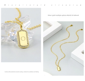 Detail of gold letter square pendant necklace with micro-pave cubic zirconia and protective plating