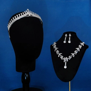 Detailed close-up of bridal jewelry set with sparkling rhinestones on black mannequin