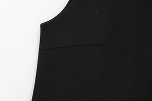Detail of high-quality black woven fabric with seamless curved hem and refined stitching