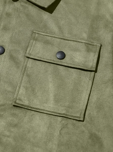 Detail of army green suede jacket showing cargo pocket and matte black button