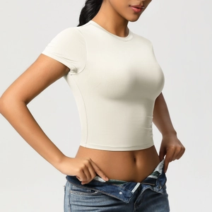 Side view of cream slim-fit yoga t-shirt showing elastic fabric and cropped cut