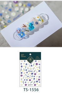 Macro detail of 3D embossed floral nail stickers featuring daisies and butterflies