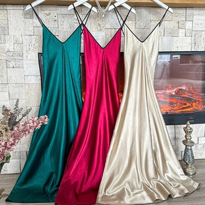 Elegant long satin slip dresses in emerald, rose, and champagne with a silky luster finish