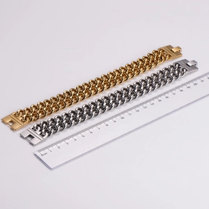 Dual-row Cuban link bracelets in gold and silver showing a length of 21cm on a ruler