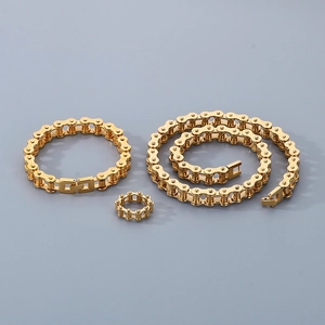 Detailed view of golden bike chain jewelry set with necklace bracelet and ring