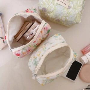 Quilted floral cotton cosmetic bag with pink and green flowers and zipper closure