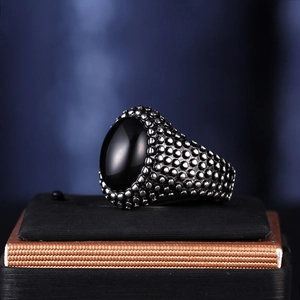 Vintage men's stainless steel ring featuring a large oval black gemstone and textured band