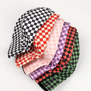 Multiple colors of checkered bucket hats stacked together on a clean white background