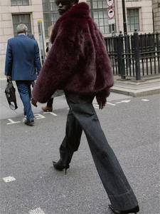 Detail of dark purple faux fur jacket with knot buckle in street style fashion
