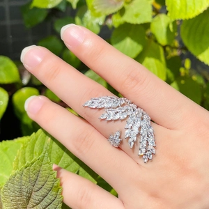 Detailed view of angel wing open ring with micro-pave cubic zirconia on model's hand