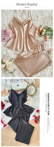 Detailed flat lay of champagne and black satin pajama sets with sleek camisole and shorts