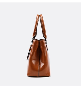 Side view of brown leather tote bag showing semi-matte texture and sturdy structure