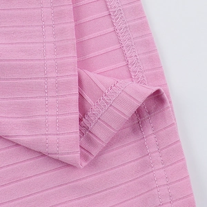 Detailed macro view of pink ribbed knit fabric texture and fine stitching on the sport set