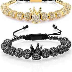 Detailed view of adjustable gold and black beaded bracelets with crown charms and zircon