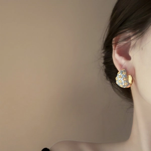 Vintage C-shaped gold hoop earrings with light blue enamel and 3D floral accents