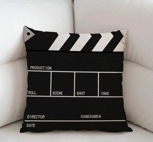 Detail of clapperboard pattern on square linen pillowcase resting on a beige sofa