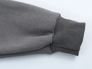 Detailed macro view of dark grey ribbed knit cuff on a soft hoodie loungewear set