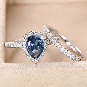 Set aus Tropfen-Zirkonia-Ring und Vorsteckring mit blauen Edelsteinen im Etui