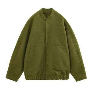Detail of olive green sherpa bomber jacket showing texture, stand collar and pockets