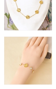 Detail view of golden flower necklace and white shell bracelet on models